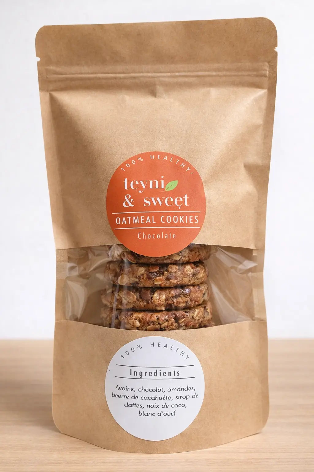 Sachet de cookies healthy à l’avoine, amandes et graines variées Teyni & Sweet, emballage kraft avec fenêtre transparente laissant apparaître les cookies artisanaux.